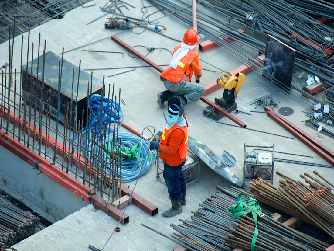 Cuadrilla trabajando con varillas de refuerzo en una obra de construcción